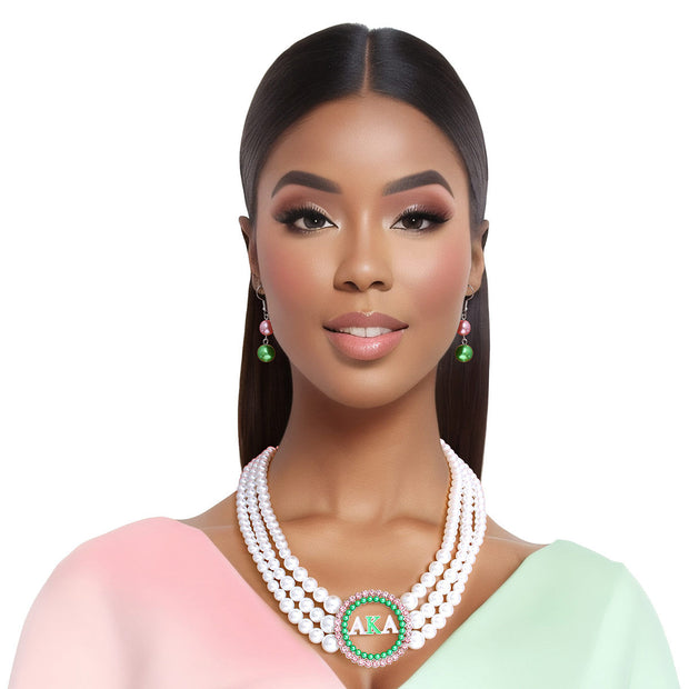 Alpha Kappa Alpha Inspired Pearl Necklace Set - Graduated white acrylic pearl necklace with green pearl studs and pink rhinestone-edged pendant. Includes matching double pearl drop earrings EJIJI Boutique