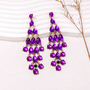 A close-up image of Sparkling Elegance Dangle Earrings, showcasing their stunning design crafted from alloy and rhinestones. The earrings measure 5.2 by 1.7 inches, making a bold yet refined statement. Embrace sophistication with lasting brilliance, but remember to avoid wear during exercise for optimal durability. EJIJI Boutique