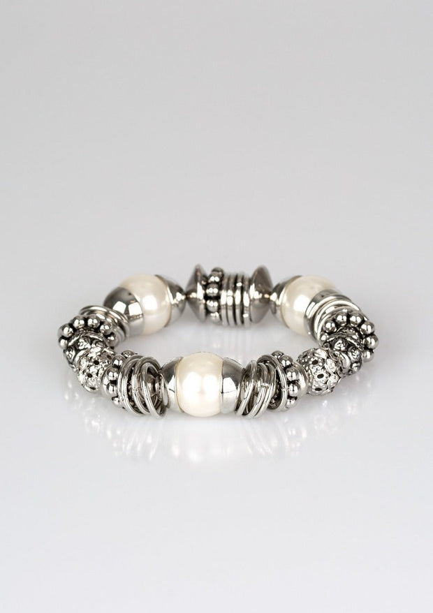 Uptown Tease - Paparazzi - Silver Stretch Bracelet - Popping Pearls A collection of oversized white pearls, mismatched silver accents, and white rhinestone encrusted beads are threaded along a stretchy band around the wrist for a show-stopping look.  Free shipping on orders over $50